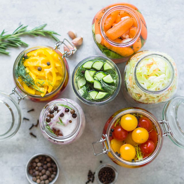 pickled vegetables salting various vegetables in glass jars for long term storage preserves vegetables in glass jars variety fermented green vegetables on table