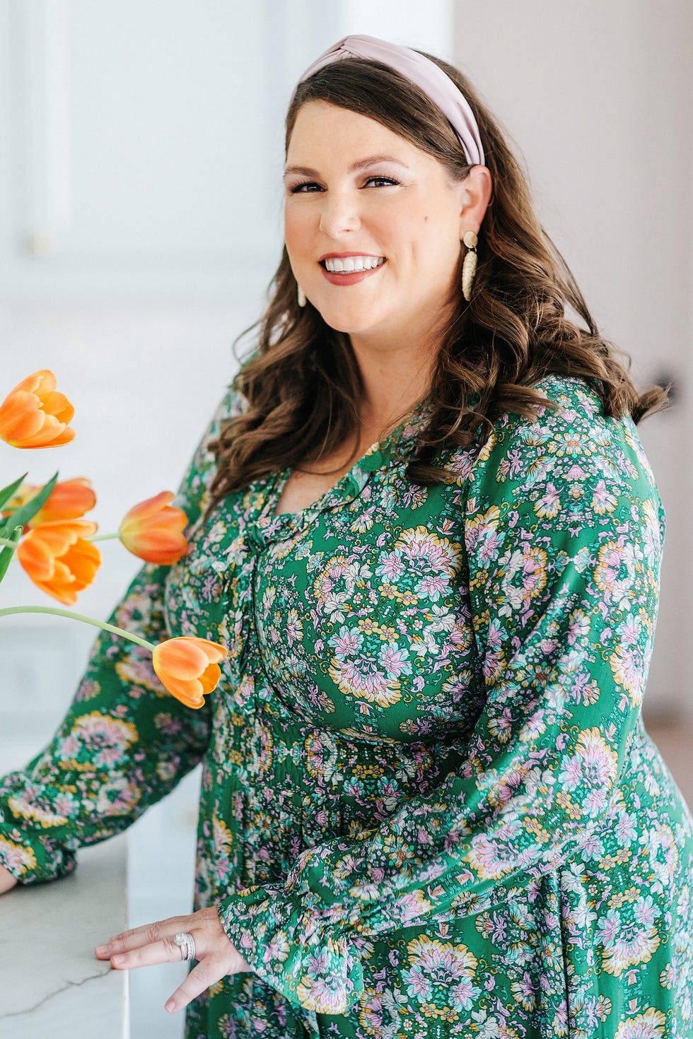 katie davis standing in front of counter in floral dress