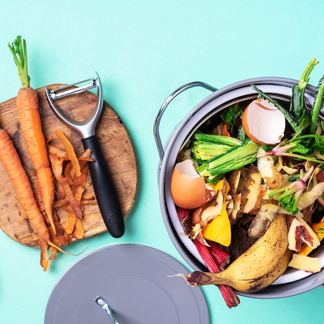 garbage sorting organic food waste from vegetable ready for recycling in compost bin on blue backgrond top view sustainable and zero waste living environmentally responsible behavior, ecology concept