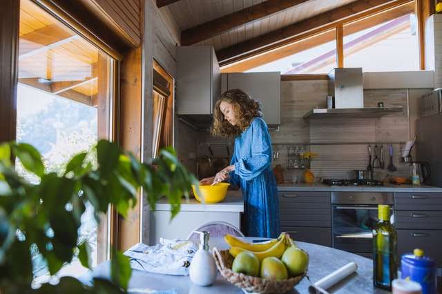 a woman cooking after a kitchen remodel