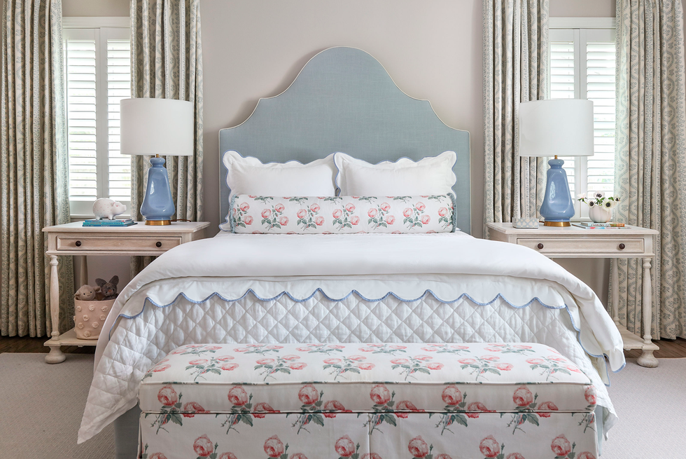 bedroom with blue headboard and floral fabrics